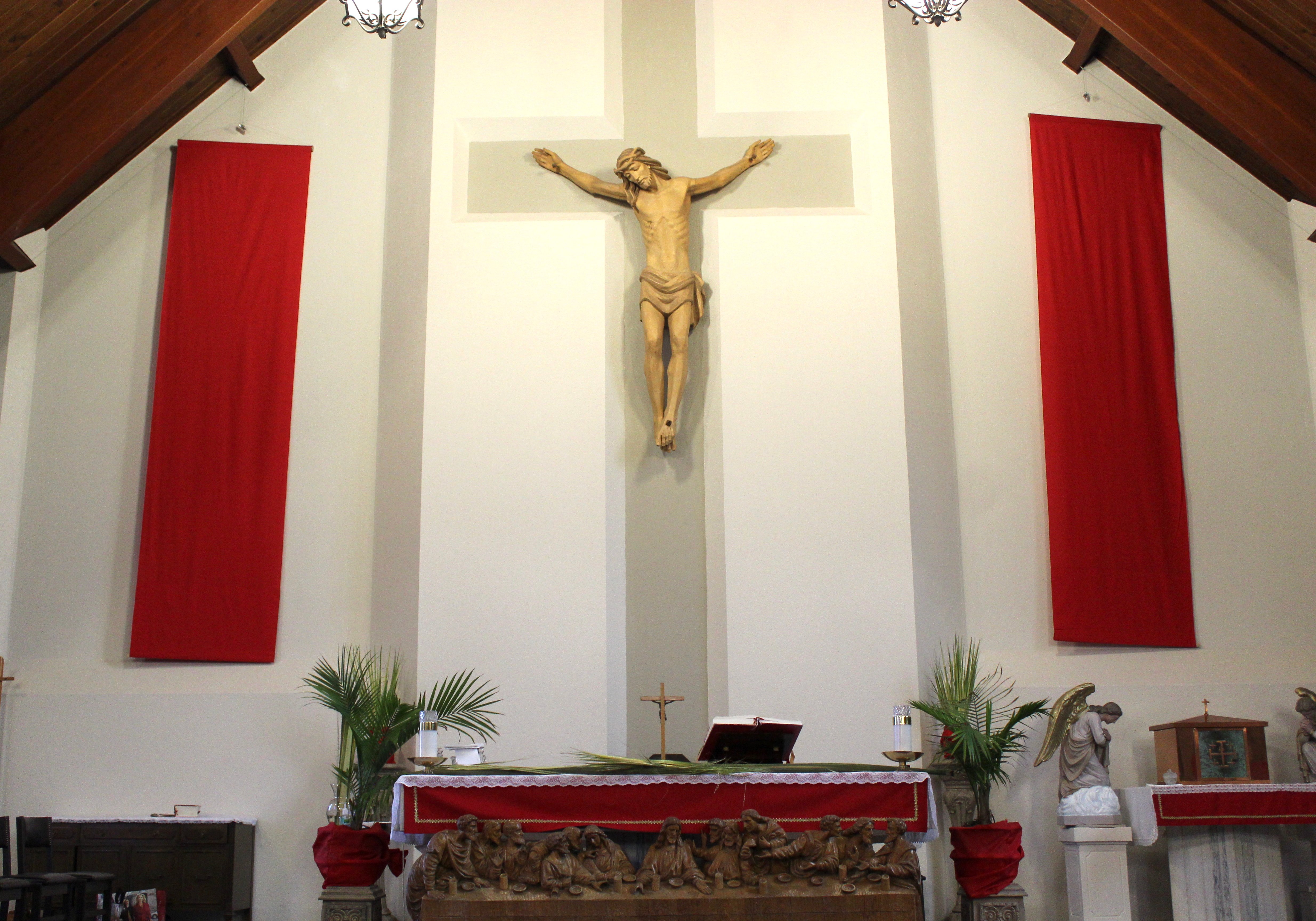 St. Jude's altar set for Palm Sunday with red altar clothes adorning the sanctuary